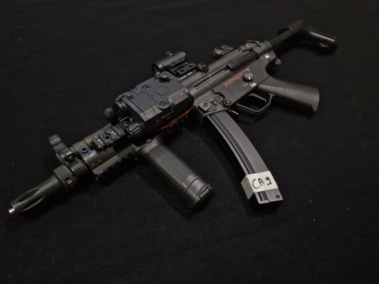Réplique airsoft type MP5 upgradée avec point rouge, laser et rail tactique